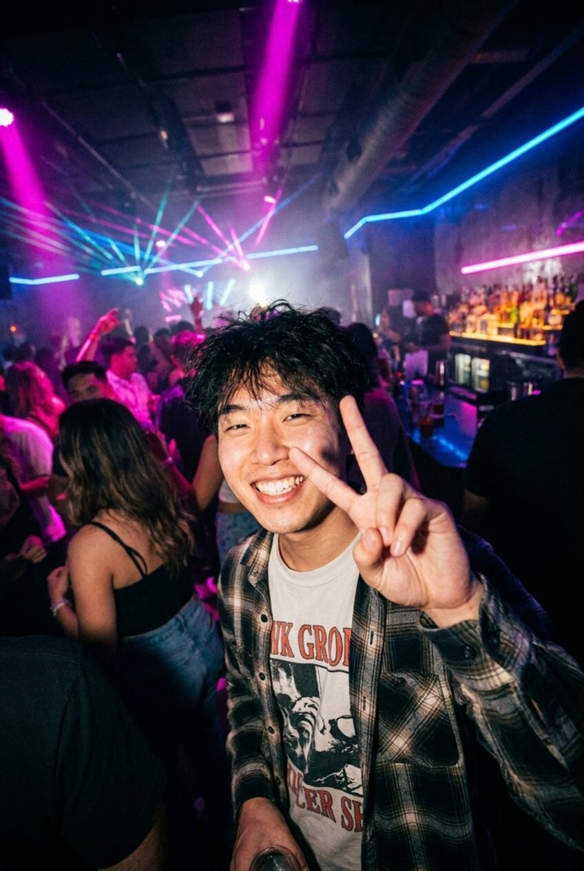 Before — a young man flashing a peace sign on a nightclub dancefloor