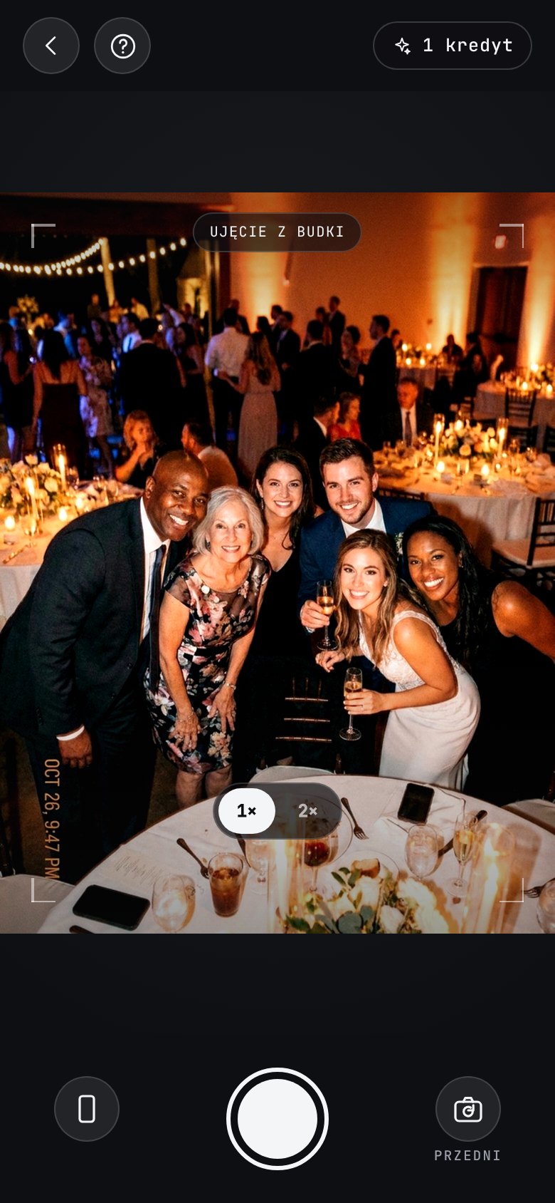 The AI photobooth in the app: a camera of its own, open on a group of guests leaning in at a candlelit reception, with a “booth shot” badge across the viewfinder, a help button top-left and the booth credits left top-right